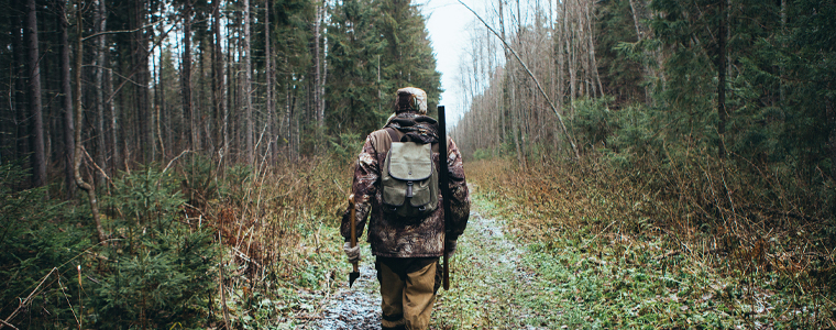 hunter walking through woods