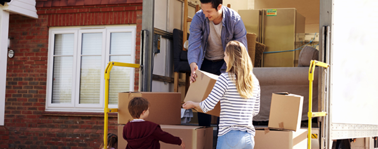 family unloading moving truck