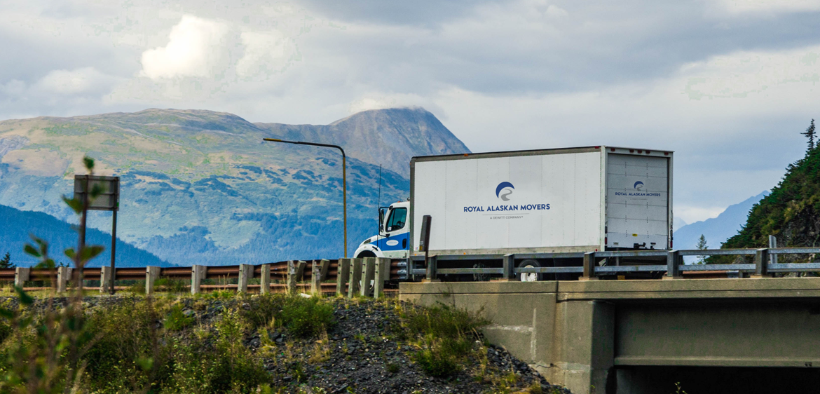 truck driving with mountains in background