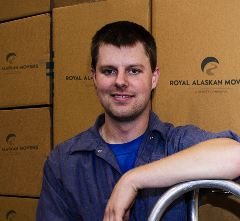 mover smiling in front of boxes