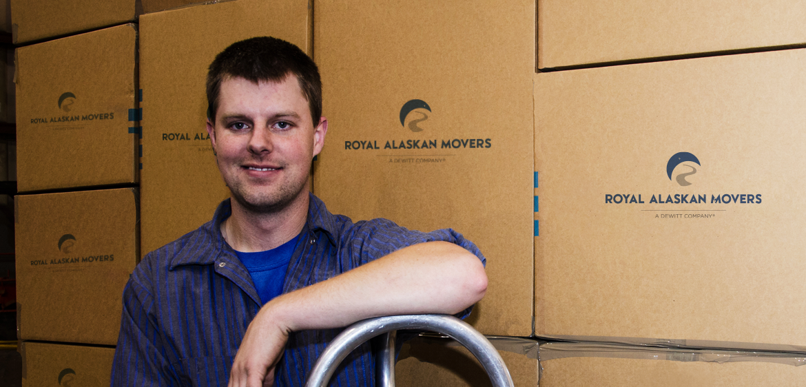mover smiling in front of boxes