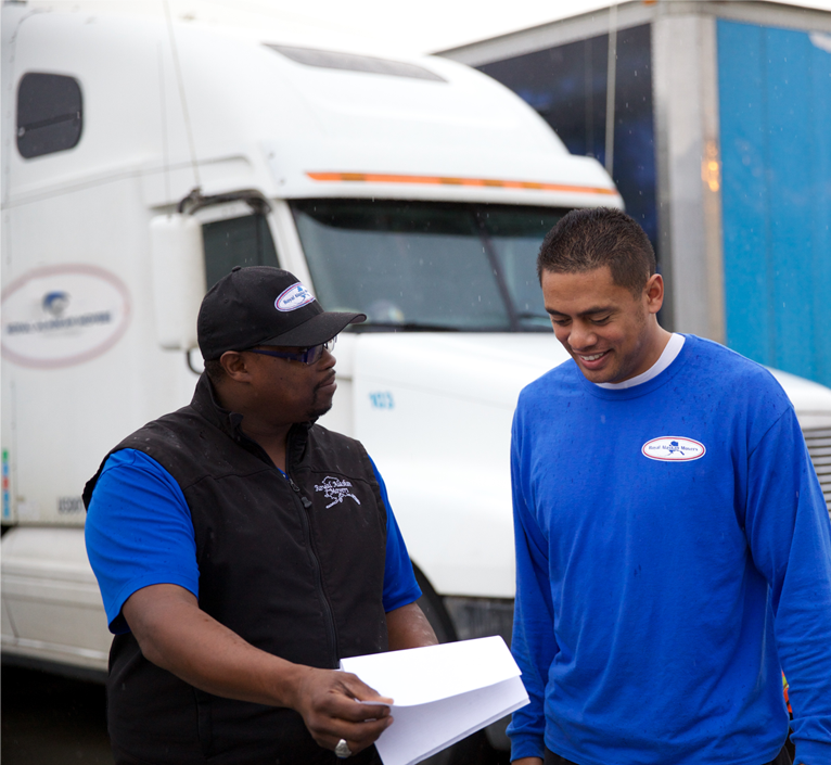 two-workers-talking-outside-2-is-right manager explaining job