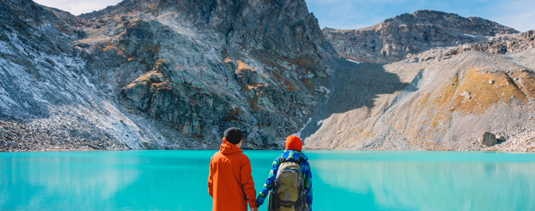 couple holding hands lake