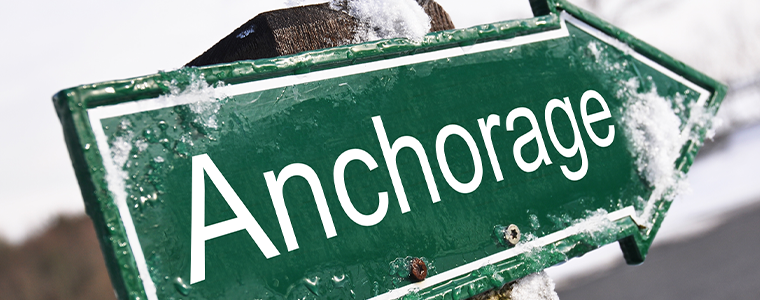 Arrow sign with snow pointing to Anchorage