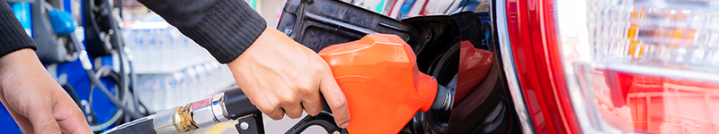 Refuel cars at the fuel pump. The driver hands, refuel and pump the car's gasoline with fuel at the petrol station. Car refueling at a gas station Gas station