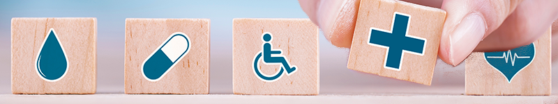 01 10 22 healthcare Businessman chooses a emoticon icons healthcare medical symbol on wooden block , Healthcare and medical Insurance concept